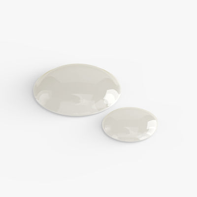 Drops of Gua Sha Face Oil on a white surface