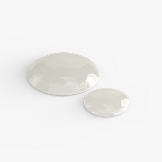 Drops of Gua Sha Face Oil on a white surface