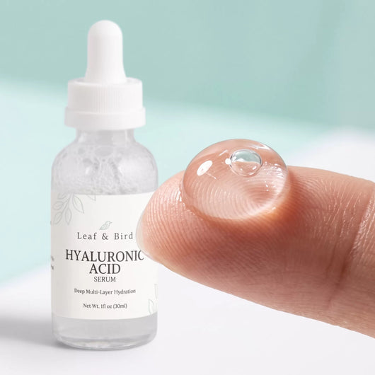 Hyaluronic Acid Serum texture: a clear gel drop on a fingertip