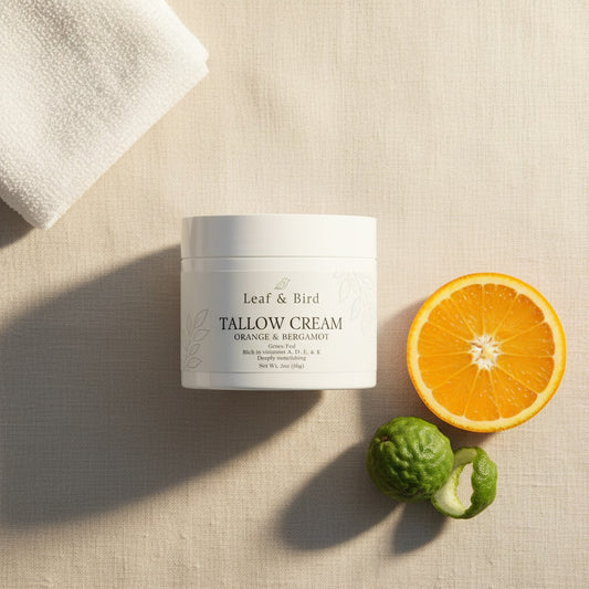Whipped Tallow Cream — Orange & Bergamot — editorial flat-lay lifestyle photo on linen